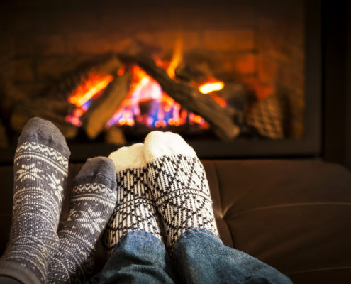Working Ventures Insurance Feet warming by fireplace